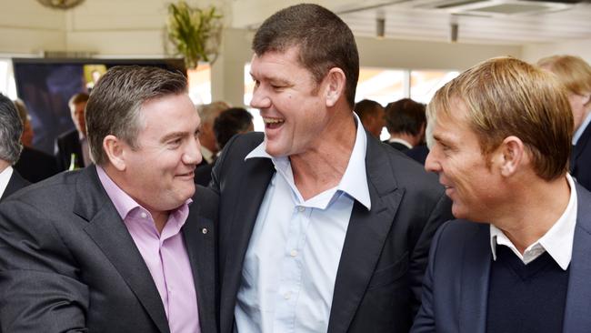 Shane Warne shakes Eddie McGuire’s hand at a party to celebrate his 30th year in media.