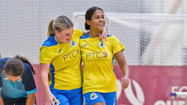 Crusaders women's players celebrate a goal.