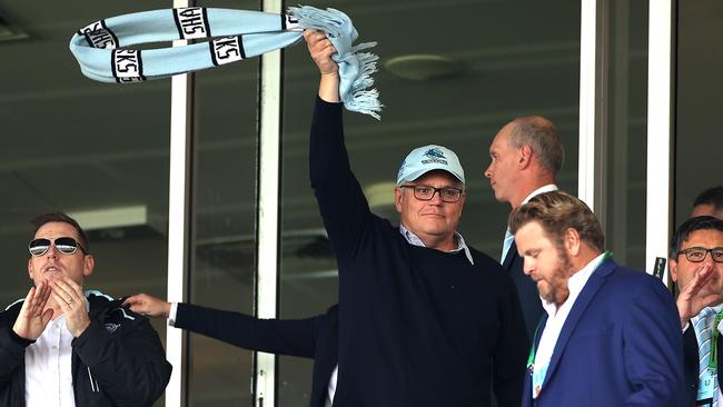 Scott Morrison flies the flag for the Cronulla Sharks after they suffered a heavy defeat against the Penrith Panthers in Sydney on Saturday. Picture: Phil Hillyard