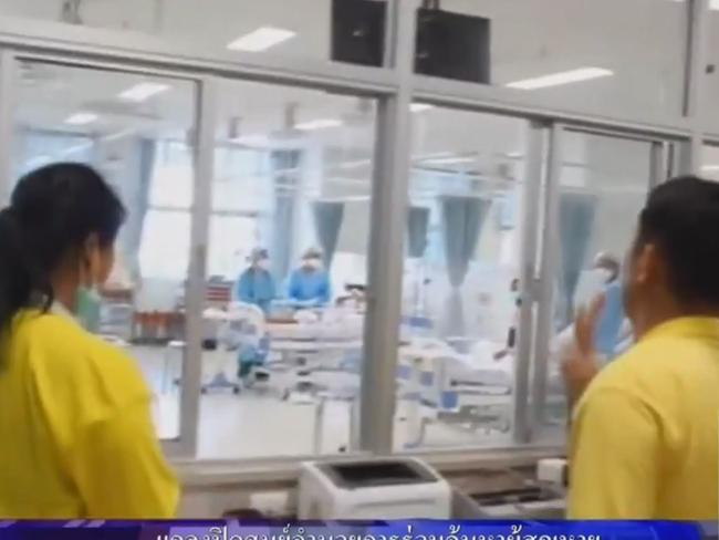 The rescued team in hospital behind a glass barrier. Picture: Supplied