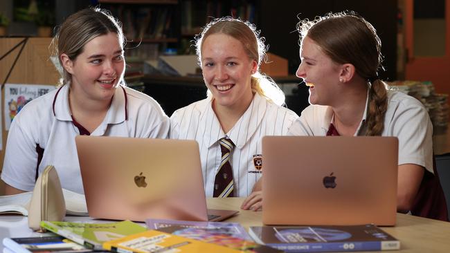 New Australian swimming star Ella Ramsay, back school at St Peters Lutheran College with school friends Victoria Kuhn 17, and Ella Kreutzer 16. Pics Adam Head