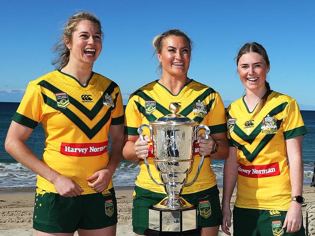 Australian Jillaroos Kezie Apps, Ruan Sims and Maddie Studdon hold the World Cup. Pic: Brett Costello