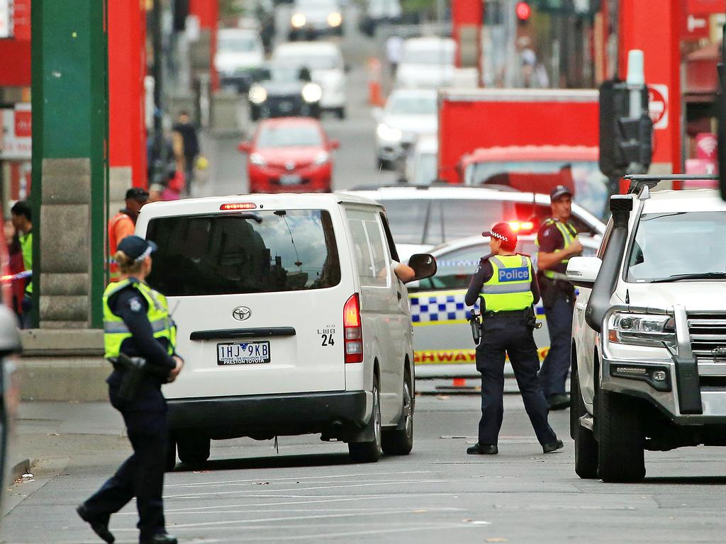 Police stand by as the Coroner’s van leaves after the grisly discovery of a woman’s body. Picture: Mark Stewart