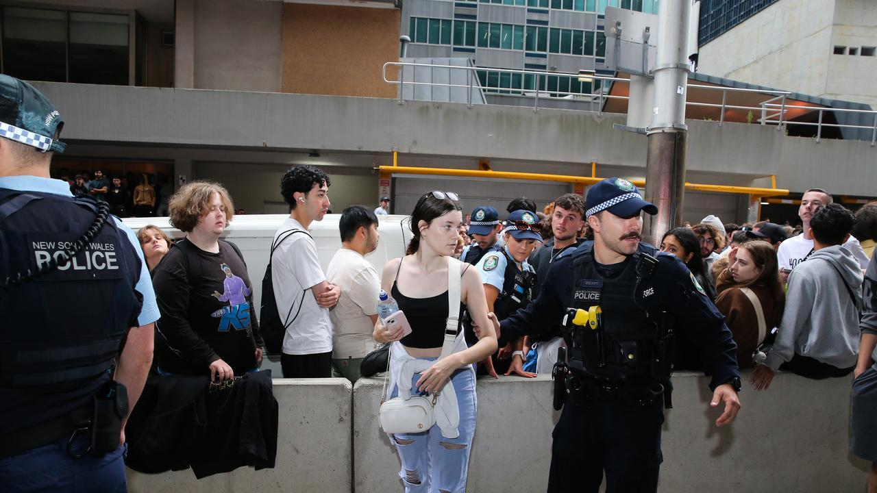 Police were seen helping a fan out of the crowd after she passed out while waiting to see Paul and KSI. Picture: NCA Newswire/Gaye Gerard