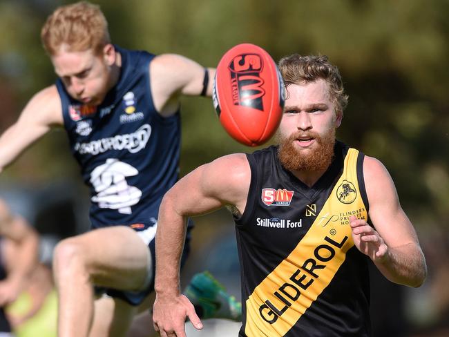 Glenelg’s Jack Haarsma chases the ball down against South Adelaide. Picture Roger Wyman