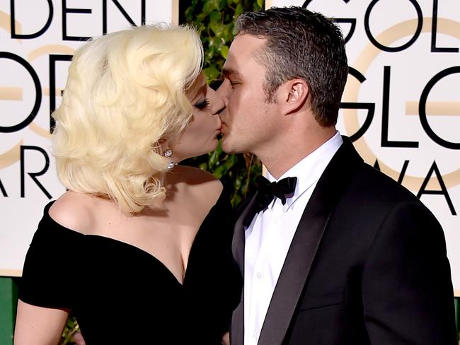 Love birds ... Lady Gaga kisses Taylor Kinney at the 73rd annual Golden Globe Awards. Picture: AP