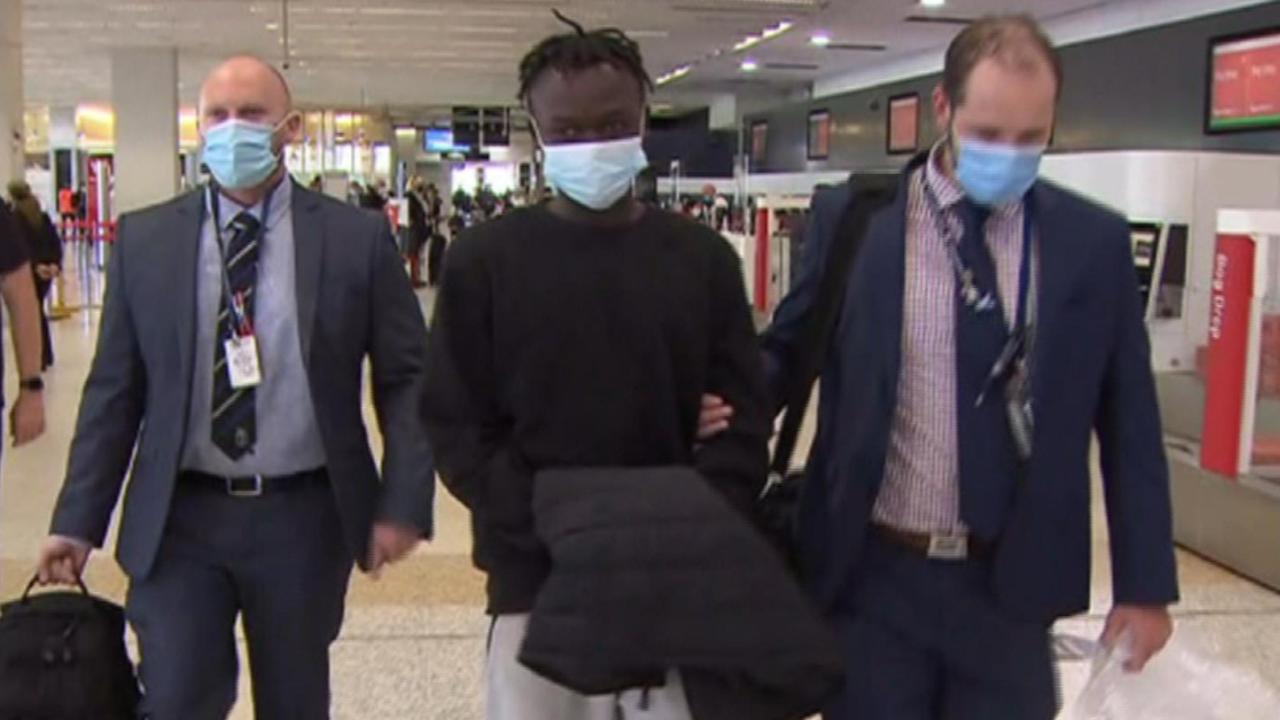 Mathiang Malok being taken through Melbourne Airport during his extradition back to SA in 2022. Picture: 7NEWS