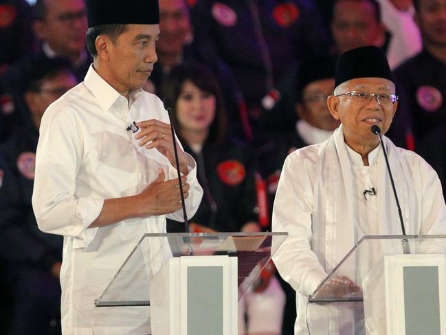 Indonesian President Joko Widodo listens as running mate Ma'ruf Amin delivers a speech during a televised debate in Jakarta. Picture: AP 