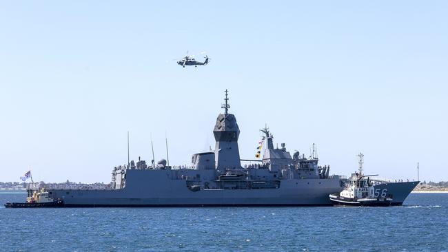 A MH-60R Seahawk helicopter conducts a fly past as Anzac-class frigate HMAS Toowoomba returns to Fleet Base West after a regional deployment. Picture: Defence