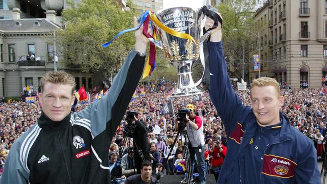 Nathan Buckley &amp; Michael Voss hold up the trophy at AFL grand final parade in 2002. Picture: HWT Library.