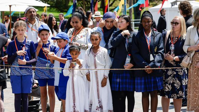 Local school students await the King and Queen’s arrival. Photo by Brook Mitchell / POOL / AFP