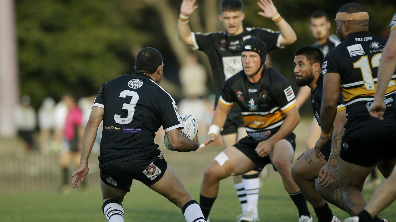 Redfern's Craig McKenzie faces a wall of Tigers. Picture: John Appleyard