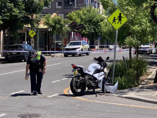 Police attend the scene of a serious crash between a motorcycle and a car in the Adelaide CBD on February 12, 2024. Picture: Duncan Evans