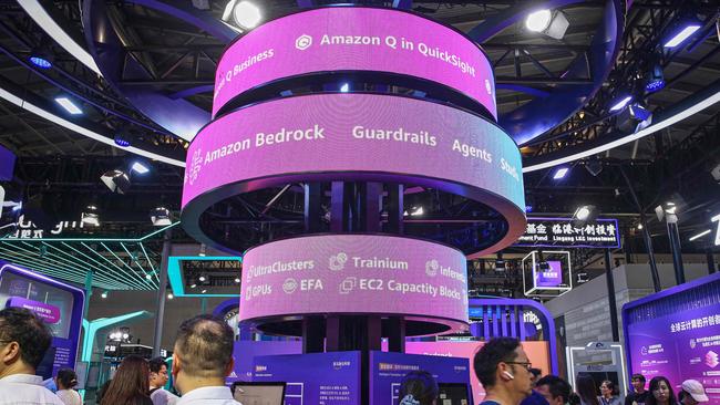 Visitors walk past an Amazon exhibition booth during the World Artificial Intelligence Conference in Shanghai in July. Picture: AFP