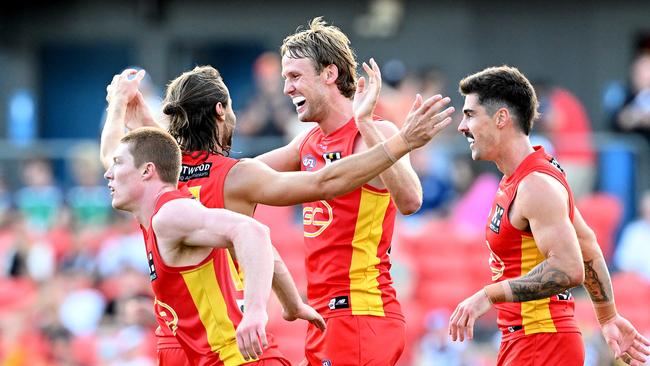 Jack Lukosius and his teammates celebrate a goal against the reigning premiers. Picture: Bradley Kanaris/Getty Images