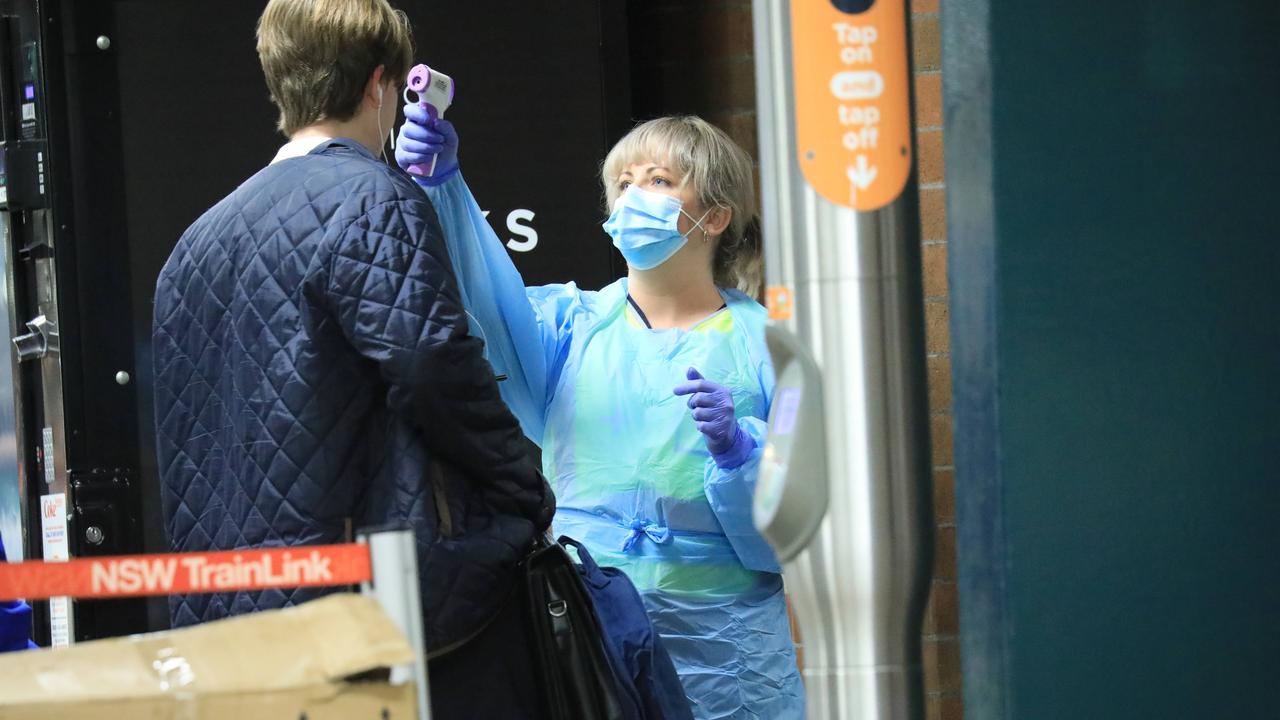 A passenger from Melbourne is temperature checked at Sydney’s Central Station. Picture: Christian Gilles