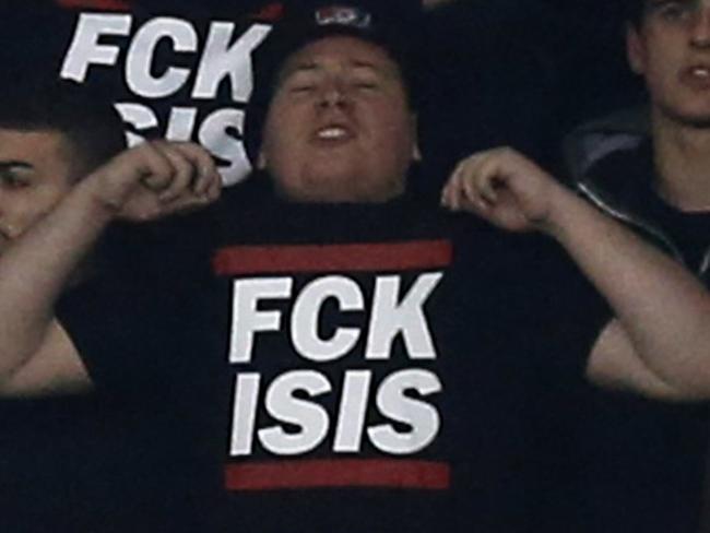 ALTERNATIVE CROP A photo taken on November 20, 2015 shows Nice's supporters holding a sign reading "Fuck ISIS", after the recent attacks in Paris, during the French L1 football match between Nice (OGC Nice) and Lyon (OL) at the "Allianz Riviera" stadium in Nice, southeastern France. AFP PHOTO / VALERY HACHE