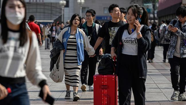 Passengers arrive at Beijing railway station on Friday. Picture: AFP