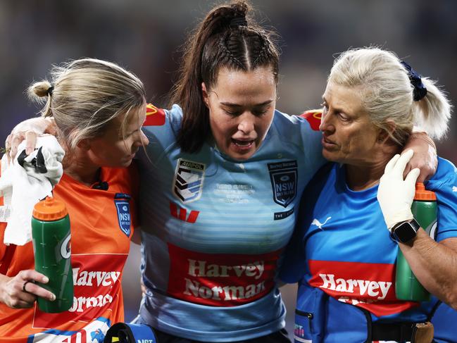 SYDNEY, AUSTRALIA - JUNE 01: Isabelle Kelly of the Blues is assisted from the field after sustaining an injury during game one of the Women's State of Origin series between New South Wales and Queensland at CommBank Stadium on June 01, 2023 in Sydney, Australia. (Photo by Matt King/Getty Images)