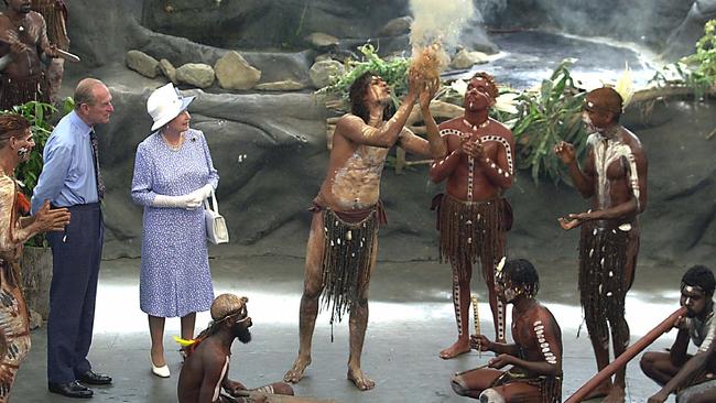 Queen Elizabeth II with and Prince Philip watch Aboriginal dancers near Cairns during the 2002 royal tour.