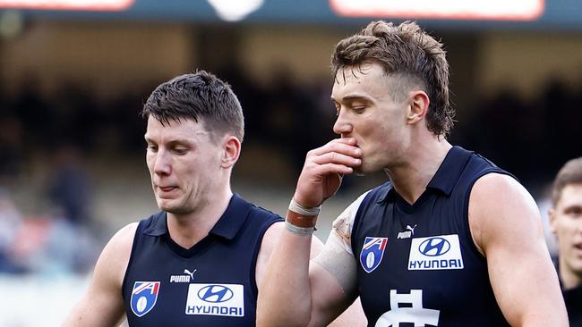 MELBOURNE, AUSTRALIA - AUGUST 11: Patrick Cripps of the Blues (centre) looks dejected after a loss during the 2024 AFL Round 22 match between the Carlton Blues and the Hawthorn Hawks at The Melbourne Cricket Ground on August 11, 2024 in Melbourne, Australia. (Photo by Michael Willson/AFL Photos via Getty Images)