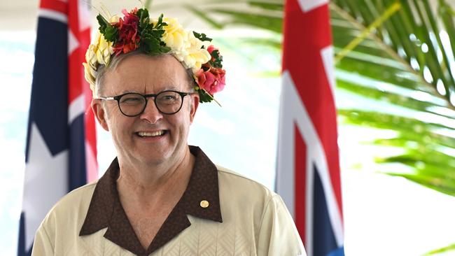 Australian Prime Minister Anthony Albanese wears a floral head piece while signing agreements with Prime Minister of Tuvalu Feleti Teo for the Australia-Tuvalu Falepili Union to come into force at the 53rd Pacific Islands Forum Leaders Meeting in Nuku'alofa, Tonga, Wednesday, August 28, 2024. Leaders from Pacific Island nations are gathering in Tonga for the 53rd Pacific Islands Forum Leaders Meeting. (AAP Image/Lukas Coch) NO ARCHIVING