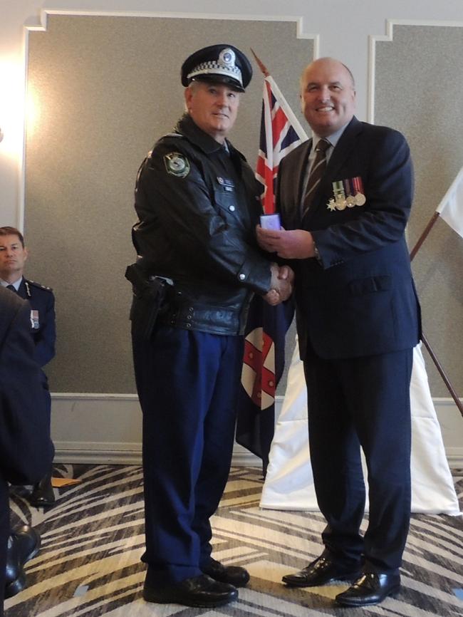 Sgt Glenn Peters receives his NSW Police Medal 30 year clasp from Baulkham Hills state Liberal MP and Minister David Elliott