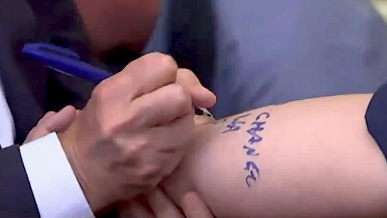 Prime Minister Anthony Albanese signed a journalist's arm on Monday pledging to maintain the federal government’s ‘fair share’ GST deal with WA. Picture: ABC