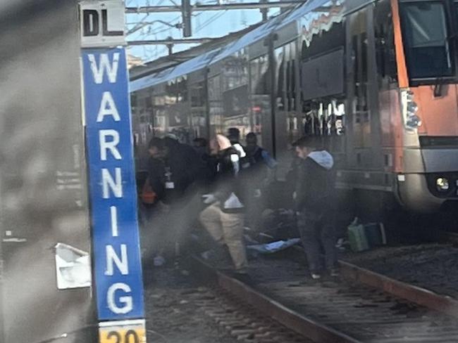 Police and paramedics were seen on the tracks during the incident. Photo: Twitter/Josh Newy