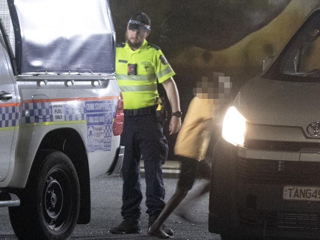 A young Indigenous Australian is released from a police cage truck and enters a local youth organisation vehicle to be returned to a camp in Alice Springs. Picture: Liam Mendes