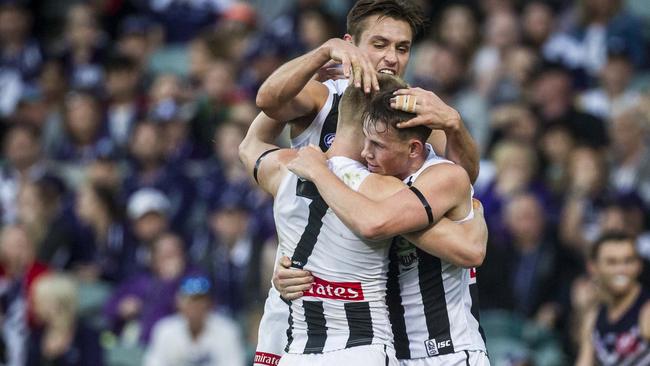 Adam Treloar celebrates a goal against Fremantle with teammates. Picture: AAP