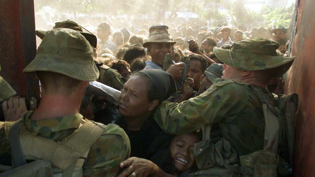 Australian INTERFET peacekeeping force attempt to control huge crowd queuing for food rations at entrance to Dili football stadium in East Timor. Picture: Supplied.