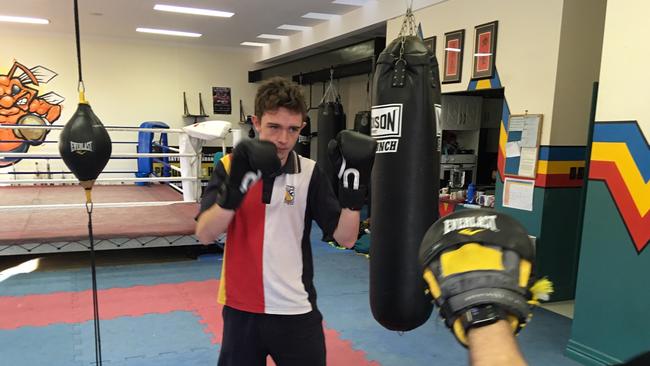 Kayne Rose does some pad work with Jeff Horn.