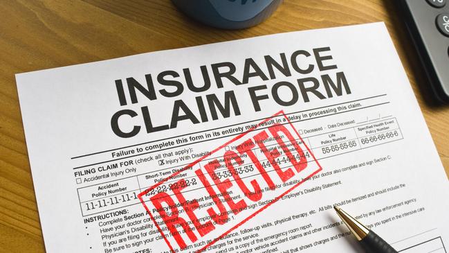 Insurance Claim Form on a desktop stamped in red "rejected.life insurance generic, claim denied, rejected