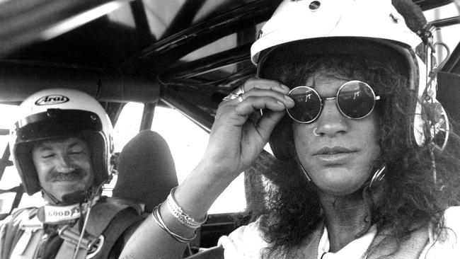 Guitarist Slash prepares for a lap of Calder Park before the Guns N’ Roses concert while a young Wayne Flower struggles to survive in the surging pit. Picture: Peter Ward/HWT archives