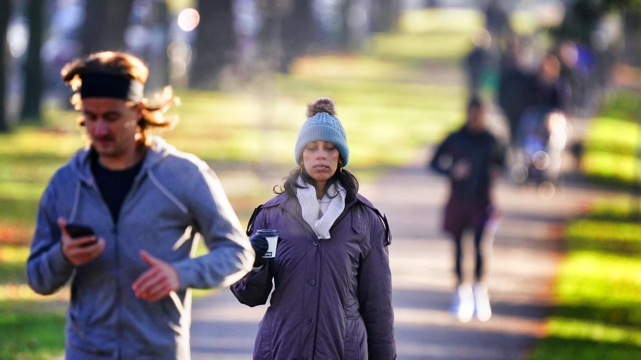 People are seen jogging rugged-up around Royal Park in Parkville. Picture: NewsWire / Luis Enrique Ascui