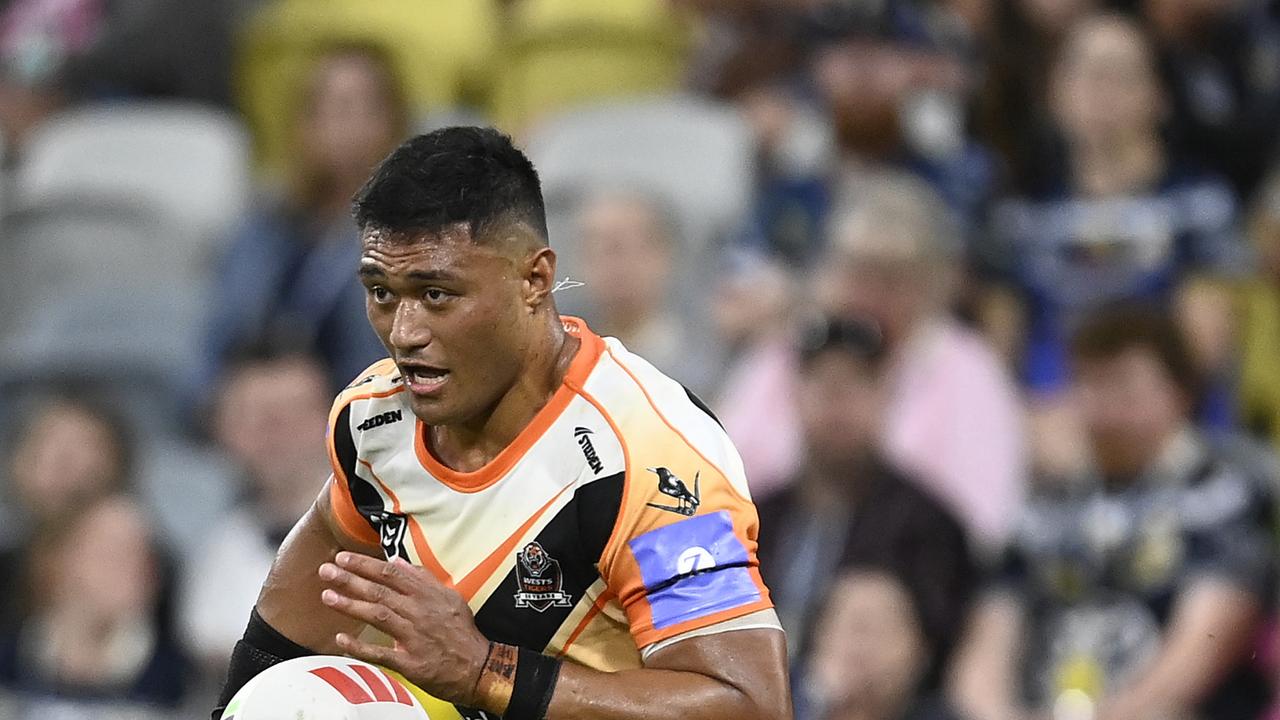 TOWNSVILLE, AUSTRALIA - MAY 24: Stefano Utoikamanu of the Tigers runs the ball during the round 12 NRL match between North Queensland Cowboys and Wests Tigers at Qld Country Bank Stadium, on May 24, 2024, in Townsville, Australia. (Photo by Ian Hitchcock/Getty Images)