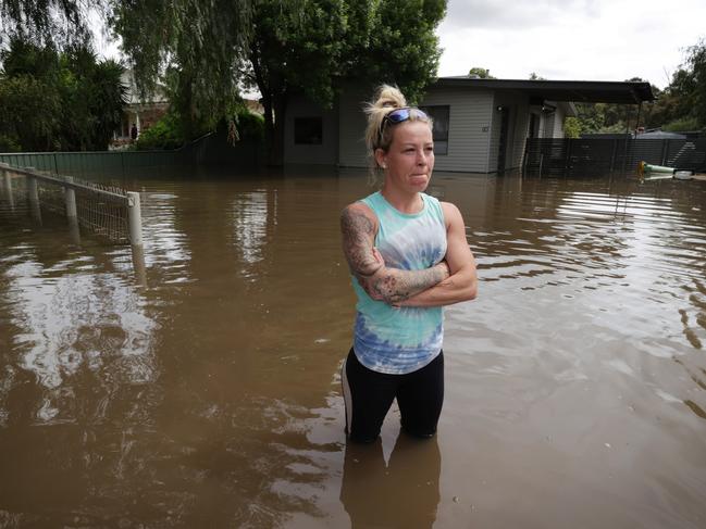 Nicole Salisbury has lost the fight to keep the water out of her house, so she helped her neighbours instead. Picture: David Caird