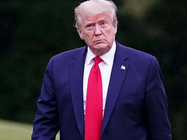 US President Donald Trump walks across the South Lawn.