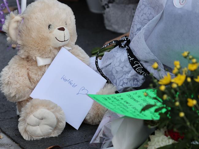 A teddy bear left at with poignant messages among the tributes. Picture: Rohan Kelly