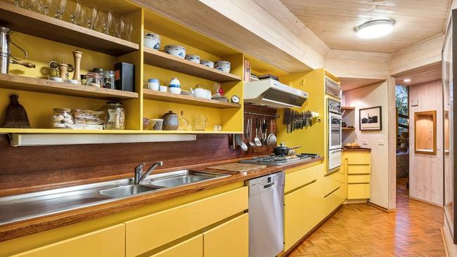 A bright yellow kitchen also features at the home.