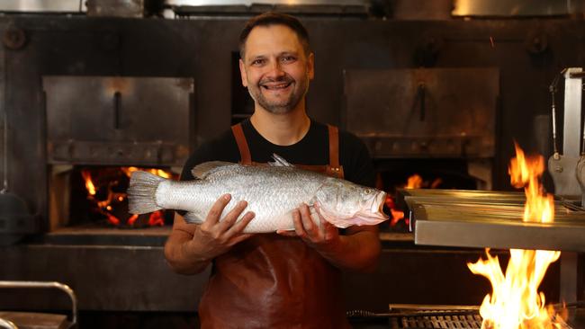 Firedoor head chef Lennox Hastie in his Surry Hills restaurant with a barramundi. Picture: Brett Costello