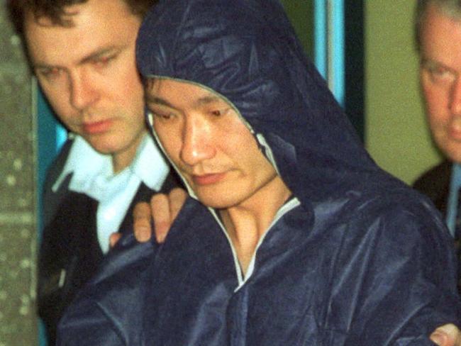 Monash University shooter Huan Yun Xiang, centre, soon after his arrest in 2002. Picture: Mark Smith