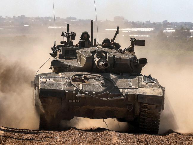 An Israeli army battle tanks moves along the border with the Gaza Strip in southern Israel on May 7, 2024, amid the ongoing conflict between Israel and the Palestinian Hamas movement. (Photo by Menahem KAHANA / AFP)