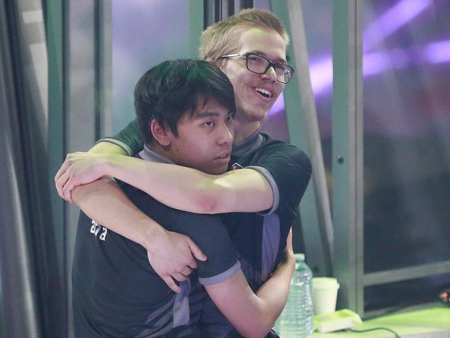 Anathan Pham (left) and Topias Taavitsainen of OG hug after their 3-2 win over PSG.LGD in Vancouver, Canada. Picture: Jeff Vinnick