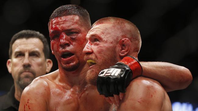 Conor McGregor, right, and Nate Diaz embrace following their welterweight mixed martial arts bout at UFC 202.