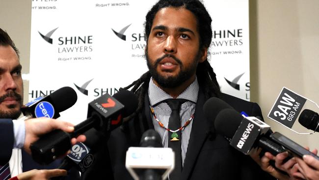 Joel Wilkinson Former AFL player suing for racial vilification and sexual harassment makes a statement to the media with Will Barsby employment law expert from Shine Lawyers.  Picture: Nicole Garmston