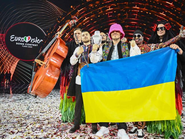 Members of the band "Kalush Orchestra" pose onstage with the winner's trophy and Ukraine's flags after winning on behalf of Ukraine the Eurovision Song contest 2022. Picture: AFP