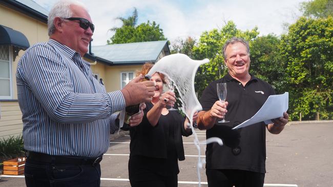 Council approving the Forest Glen Village Centre was celebrated with a bottle of champagne on Friday by Sancus Property principal Tony Riddle and Whites IGA owners Roz and Michael White. Picture: Tegan Annett