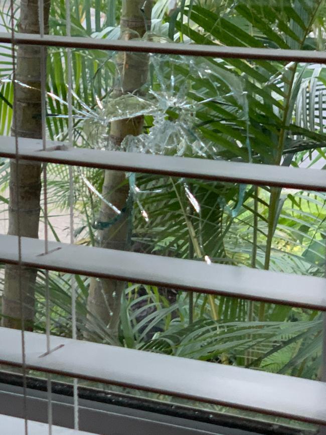 A smashed glass window in the house.